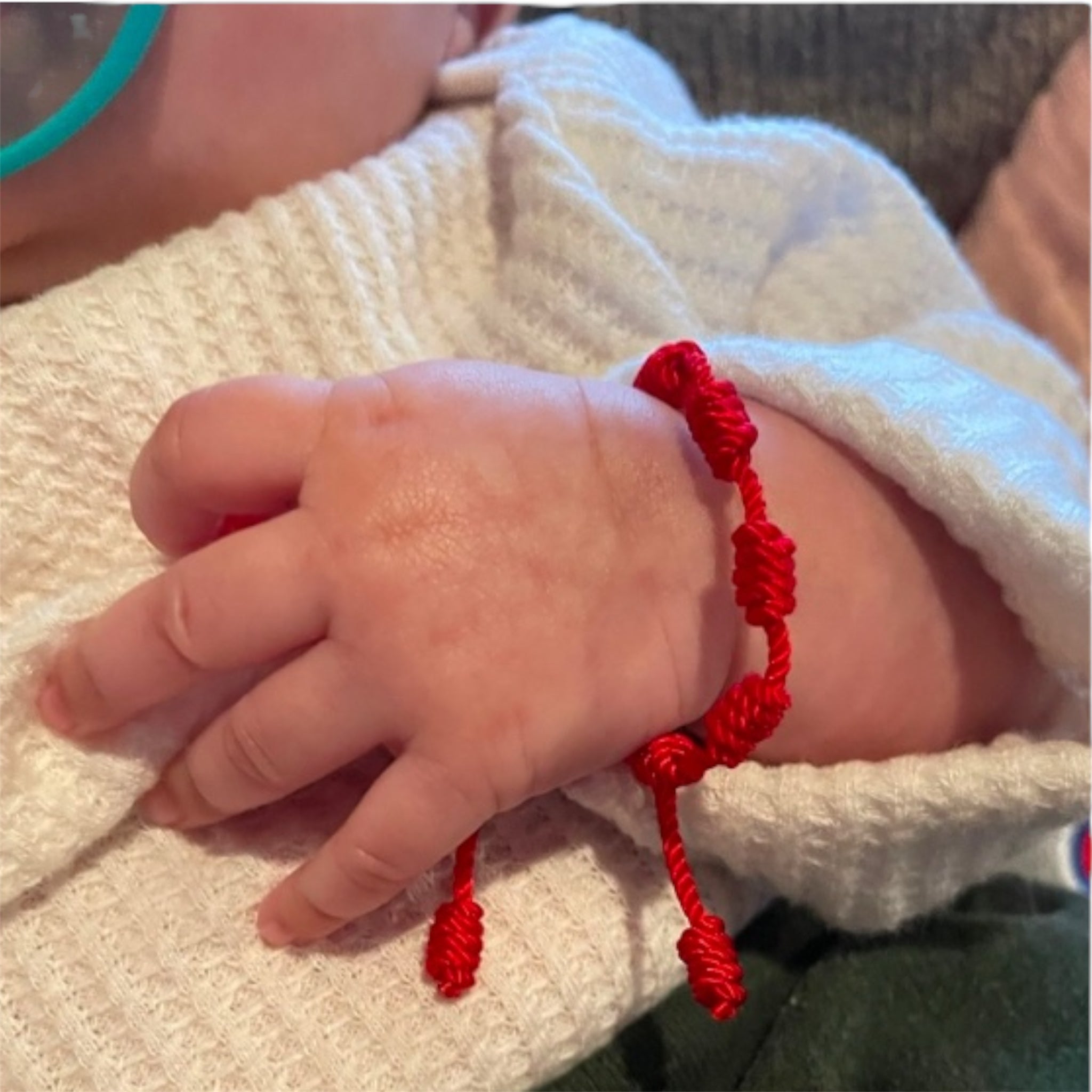 red baby bracelet for the evil eye 7 knots