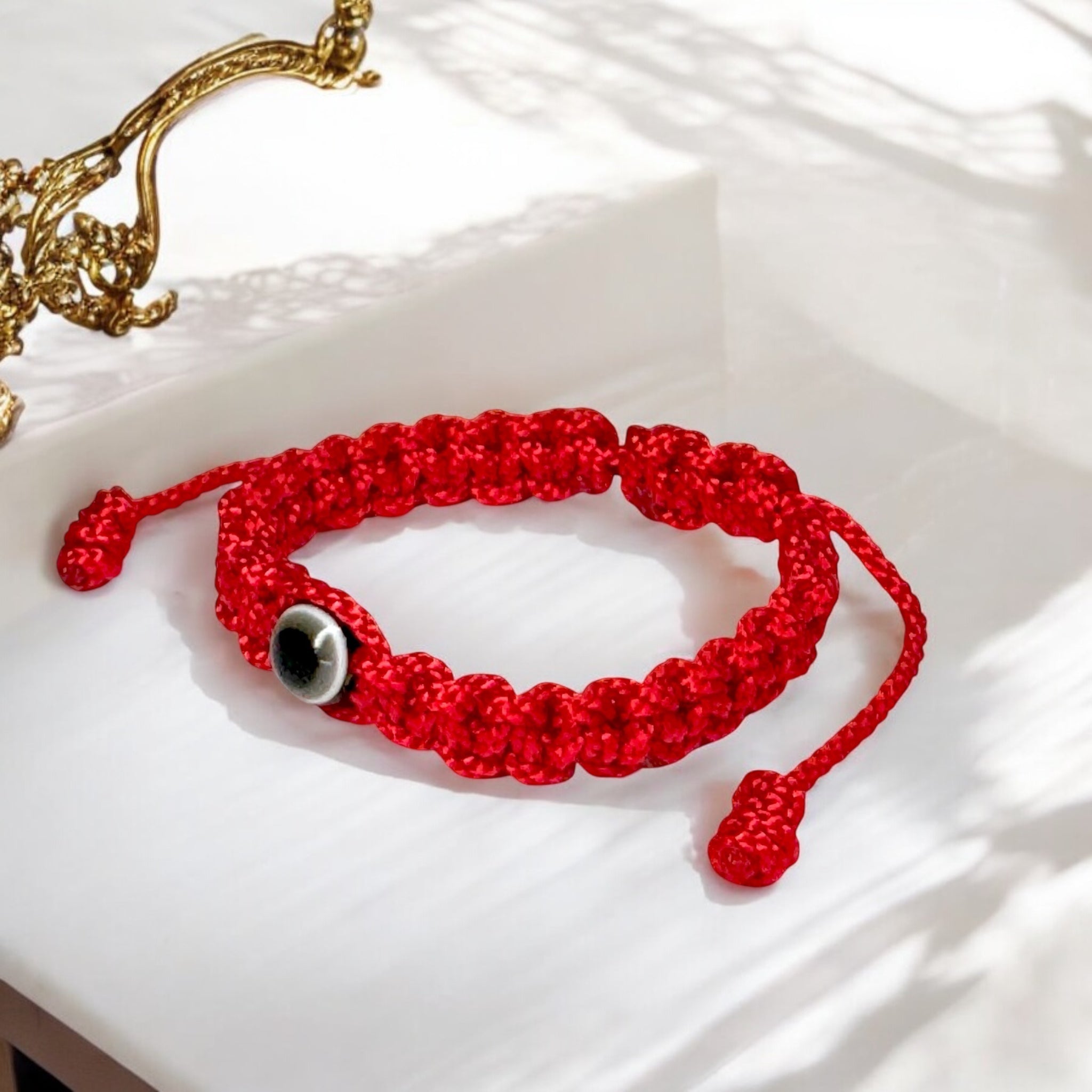 Red baby evil eye bracelet with black eye