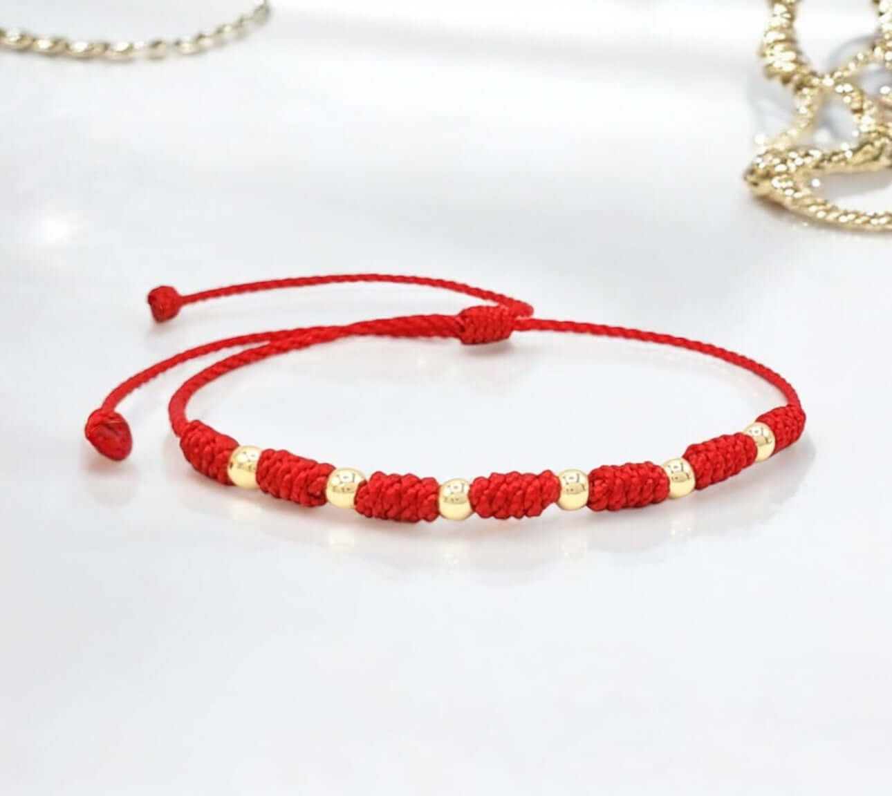Protect your baby with the 7-Knot Bracelet featuring 14k gold beads.